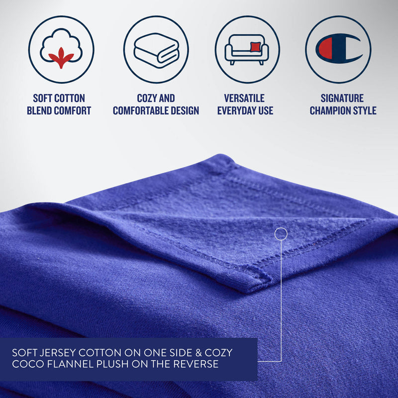 The Champion Jersey with Fleece Backing Throw Blanket is shown folded, featuring a label that highlights soft jersey cotton on one side and plush fleece on the reverse. Above are icons and text describing its comfort, cozy design, versatile use, and signature Champion style—making it the ideal athletic blanket for lounging or sporting events.